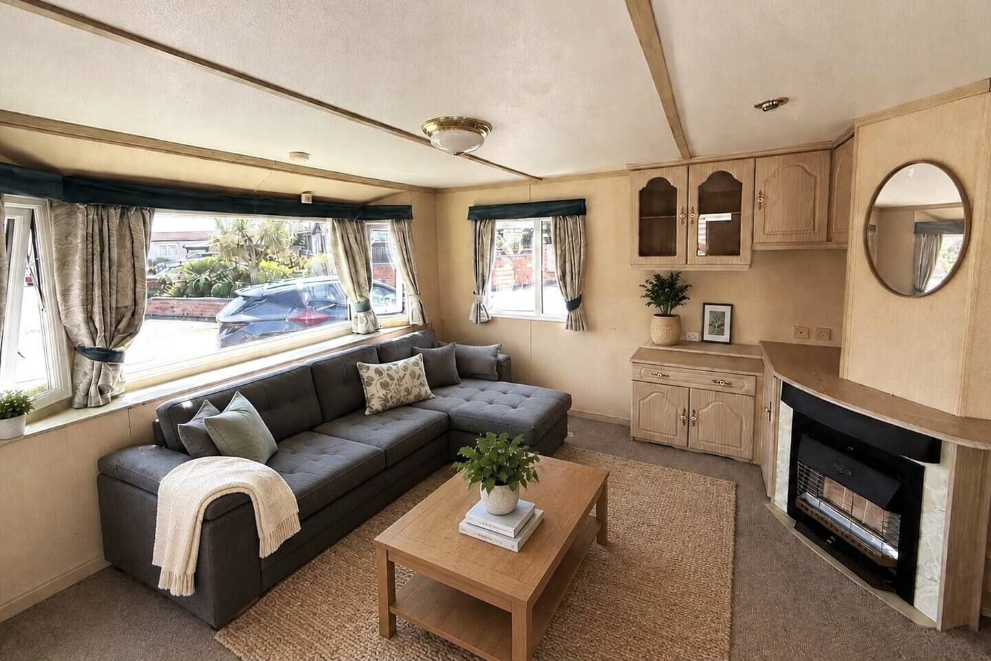 A cozy living area with a sofa, a coffee table, and a fireplace.