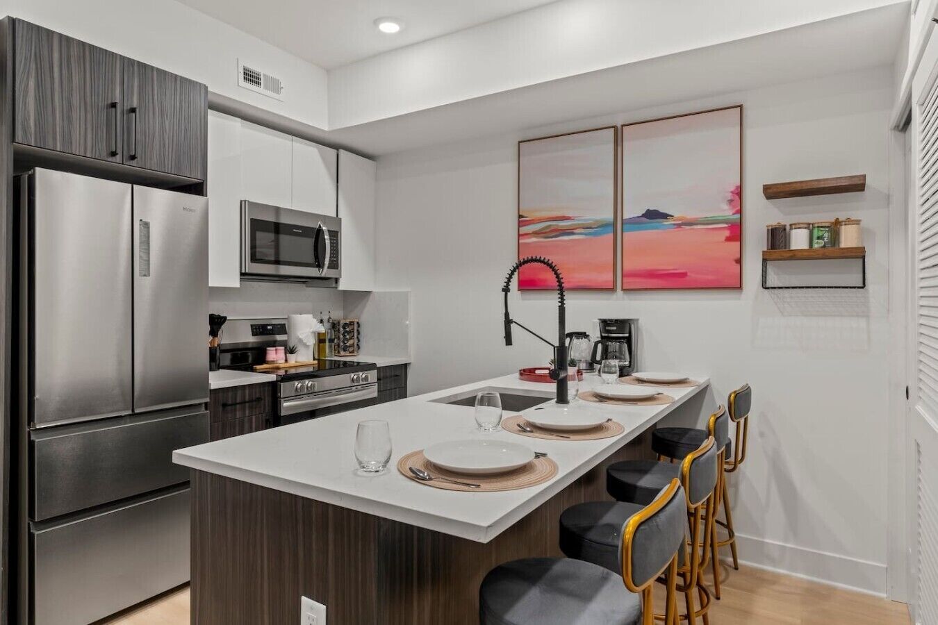 A modern kitchen with a central island, stainless steel appliances, and a minimalist design.
