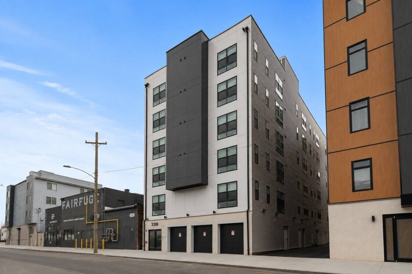 A multi-story building with a flat facade, several windows, and a ground-level entrance.