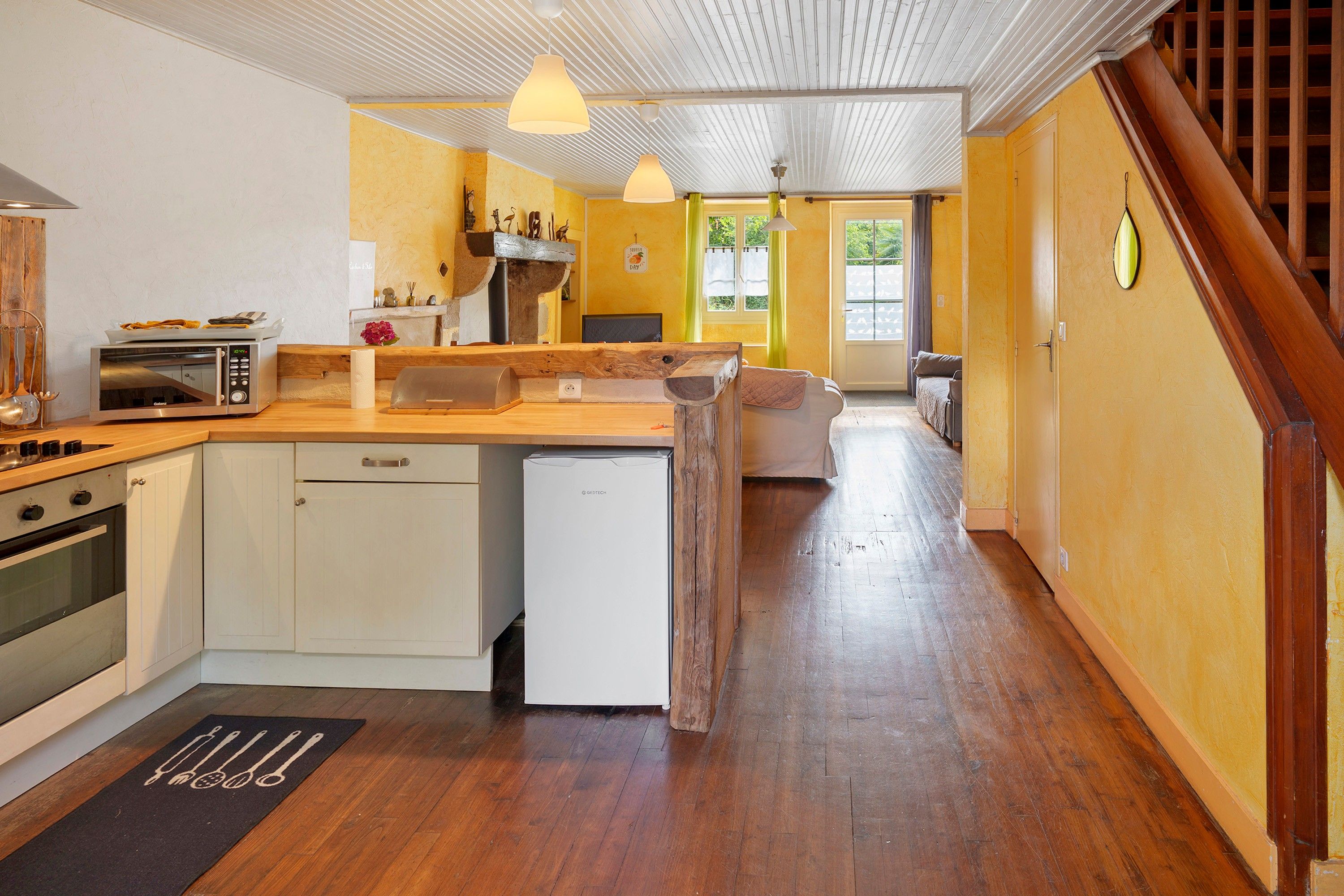 A kitchen with a wooden countertop, a dishwasher, and a built-in oven.