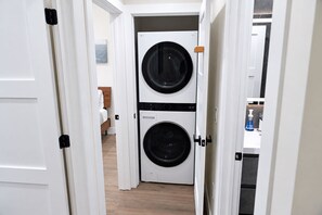 A laundry room with two stacked front-loading washing machines. - Spectacular Waterfront Home - Coral Lagoon Unit #8 (Marathon)