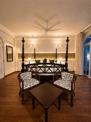 A room with a round table, four chairs, a ceiling fan, wall sconces, and a large window with curtains. - Marvelous 6-bedroom bed & breakfast in the heart of Kandy (Kandy)
