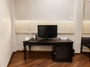 A dark wooden desk with a flat-screen TV, a kettle, and a cup in a hotel room. - Marvelous 6-bedroom bed & breakfast in the heart of Kandy (Kandy)