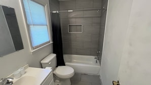 A bathroom with a toilet, sink, and bathtub. - Roomy 5BR Near I-95 & Fort Bragg - Family, Group & Work Stays (Fayetteville)