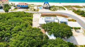 A coastal property with a beach view, a swimming pool, and a covered outdoor area. - Just Beachy, Private Pool, Beach Front (Saint George Island)