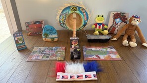 A wooden spinning top, a plush toy, a puzzle, and a small flag. - 3-br house, Vega Baja with AC and next to natural preserve. 4 minutes to beach (Vega Baja)