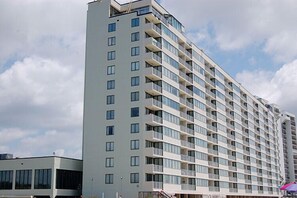 A multi-story hotel with a modern design, featuring balconies on each floor and a flat facade. - Oceanfront Condo with Balcony and Beach Views — Shore Drive, Myrtle Beach (Myrtle Beach)