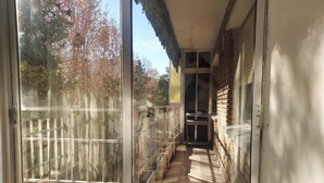 A narrow corridor with a wooden fence on one side and a brick wall on the other.