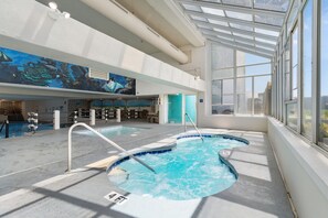 An indoor swimming pool with clear water, a diving board, and a mural on the wall. - Oceanfront Condo with Resort Pool, Hot Tub and Indoor Pool — Garden City Beach, (Garden City Beach)