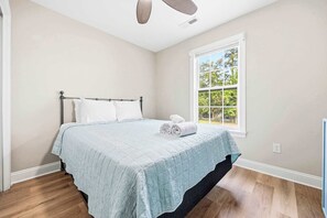A bedroom with a bed, a window, and a ceiling fan. - Perfect Inlet Stay Minutes to MarshWalk & Water (Murrells Inlet)