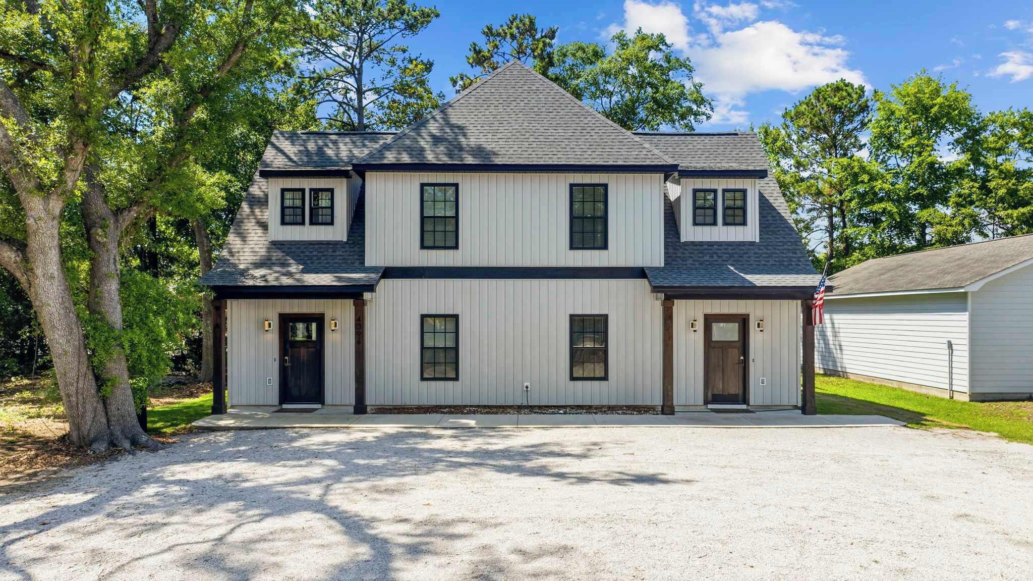 A two-story house with a symmetrical facade, a front porch, and a garage.
