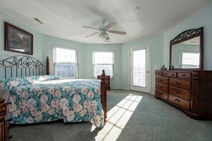 A bedroom with a bed, dresser, and ceiling fan. - Lakeview Condo (Kimberling City)