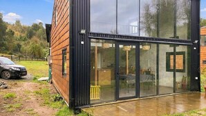A modern building with large glass windows and a brick exterior.