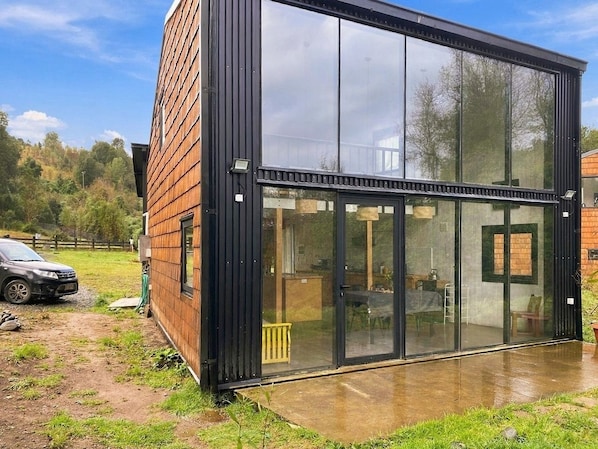 A modern building with large glass windows and a brick exterior.