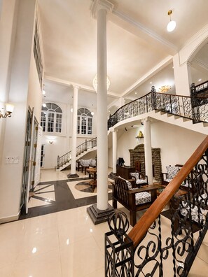 A spacious lobby with a grand staircase, high ceilings, and classical architectural details. - ceylon Breeze kandy (Kandy)