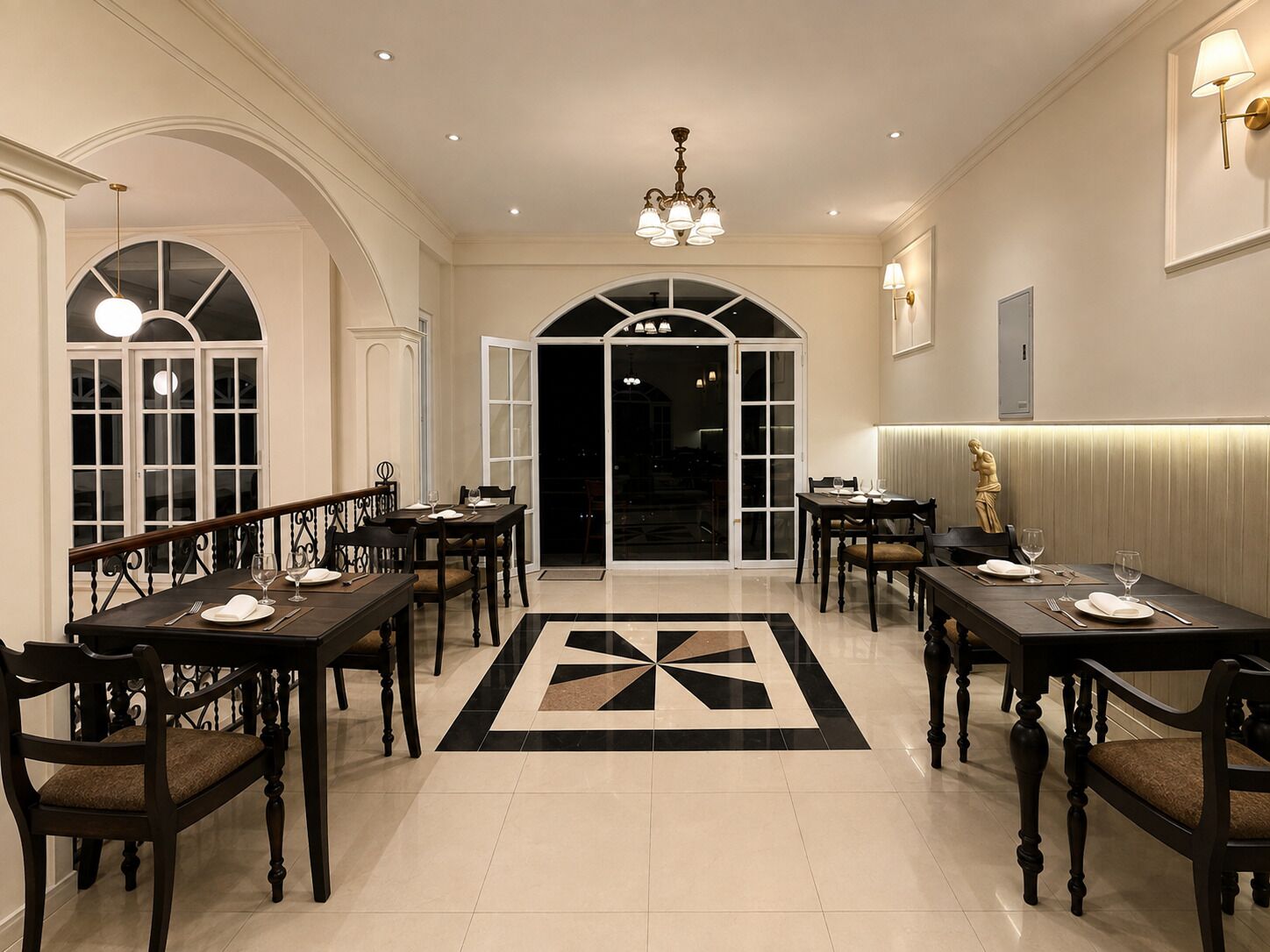 A formal dining area with multiple tables, chairs, and a geometric patterned floor.
