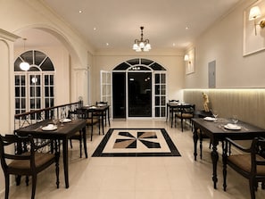 A formal dining room with multiple tables, chairs, and a geometric patterned floor. - ceylon Breeze kandy (Kandy)