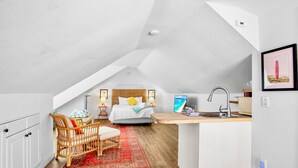 A compact, modern apartment with a loft bedroom, a small kitchenette, and a dining area. - Sunrise Garden Resort (Anna Maria)