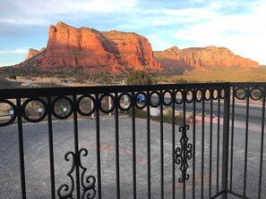 A fenced area with a mountain in the background.