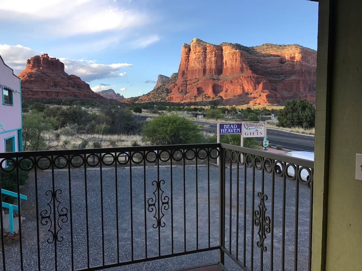 A gated entrance with a view of red rock formations and a sign for 'Bead Heaven Christmas Gifts.'