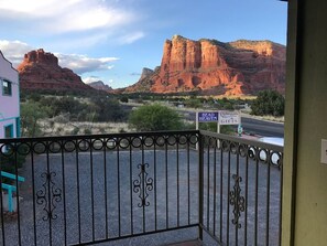 A gated entrance with a view of red rock formations and a sign for 'Bead Heaven Christmas Gifts.' - Trail Head Condo - Castle Rock (Village of Oak Creek)