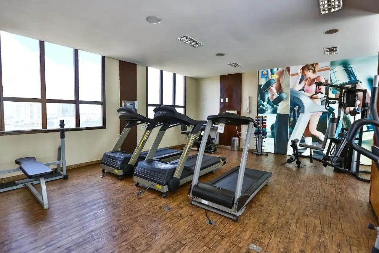 A gym with treadmills, a bench, and exercise equipment.
