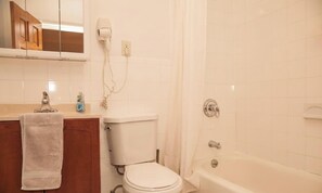 A bathroom with a toilet, sink, and bathtub. - Your Comfy NYC Home Base! 5BR/3BA Townhome in Midtown East! (New York)