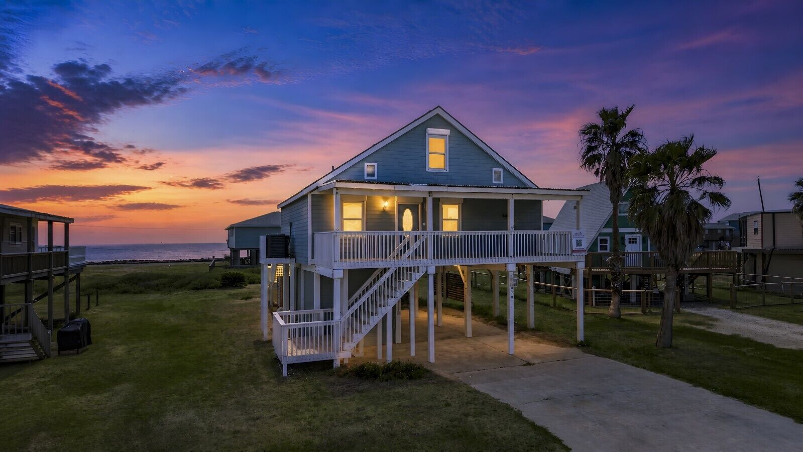 A two-story house with a balcony and a staircase leading to the upper level.