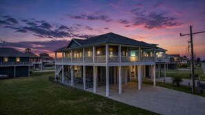 A two-story waterfront property with a covered deck and a small tower. - Seadriftin Away - Walk to Beach / Sleeps 12 (Crystal Beach)