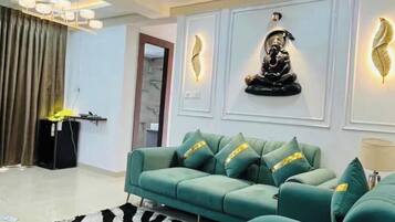 A modern living room with a sectional sofa, decorative wall art, and a patterned rug.