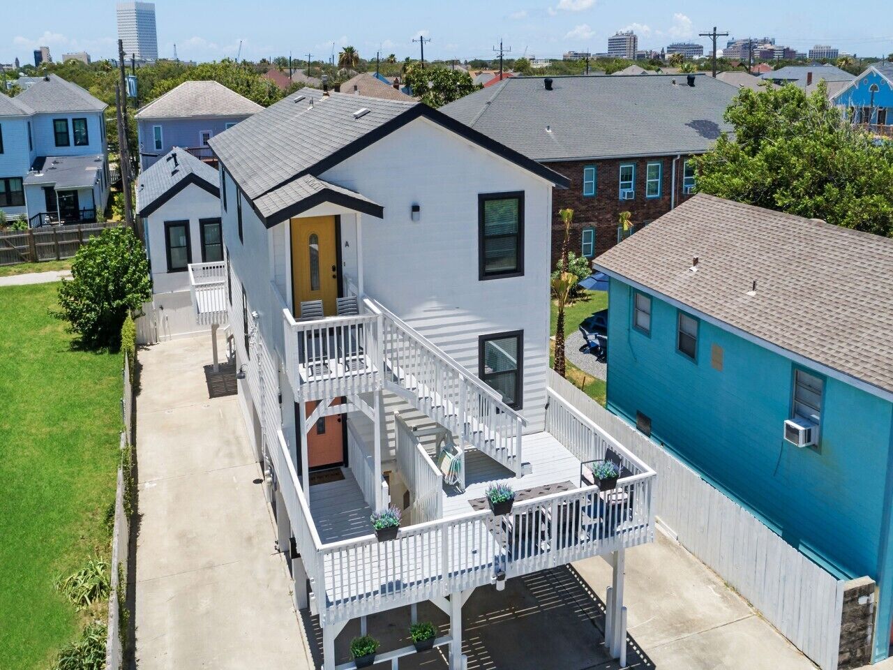 A two-story house with a front porch, a staircase, and a small deck area.