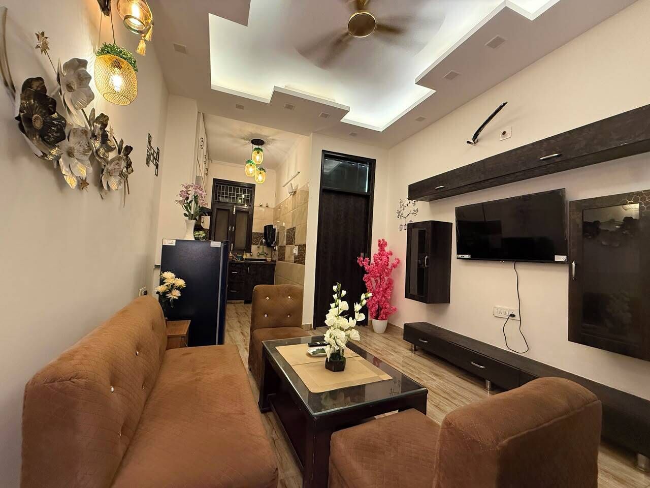A modern living room with a sofa, coffee table, and TV.