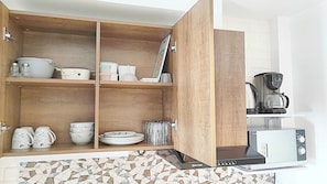 A kitchen with wooden cabinets, a coffee maker, and a toaster.