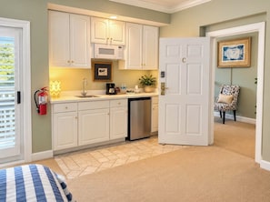 A compact kitchen with white cabinets, a microwave, and a dishwasher. - Luxury Fairway Escape-Golf and Water Views (Chapel Hill)