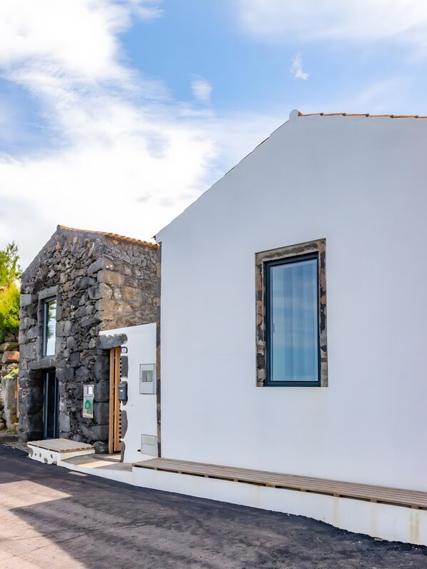 A modern building with a stone facade and a white exterior wall.
