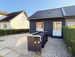 A residential building with a paved driveway, a mailbox marked with the number 48, and a door with a window. - 4 Star Holiday Home in Skanderborg (Skanderborg)