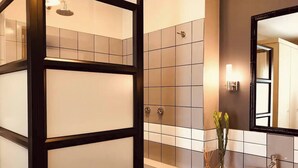 A modern bathroom with a white sink, a mirror, and a shower enclosure. - Undiscovered Gem in Rosebank 2BR (Johannesburg)