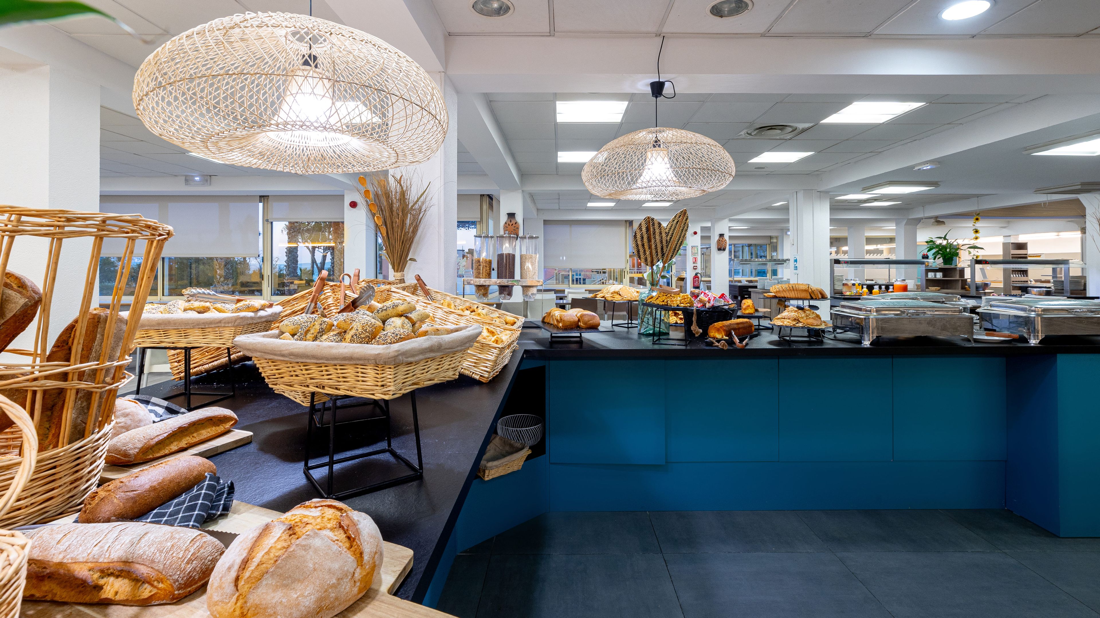 Ein modernes Frühstücksbuffet mit Korbflechtern und einer Auswahl an Brot.