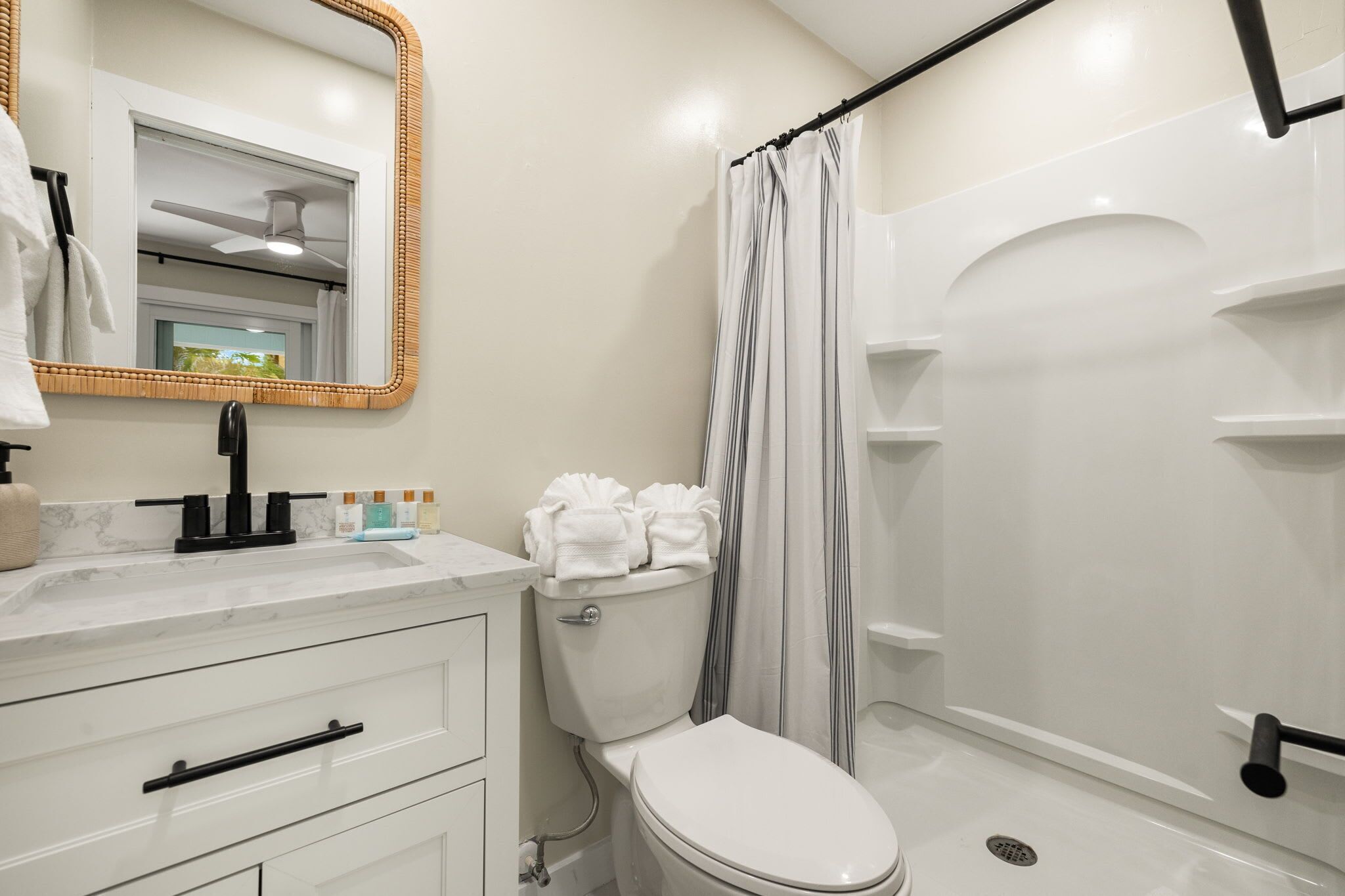 A modern bathroom with a toilet, sink, and shower.