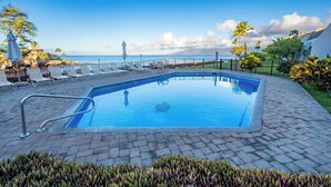 A rectangular pool with a metal ladder, surrounded by lounge chairs and a paved deck. - Villa, Oceanfront, 1-bedroom (Napili-Honokowai)