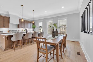 A modern kitchen with a central island, bar stools, and pendant lighting. - Luxury Massive Townhome, Pool, Private Elevator, Amenities in Murfreesboro (Murfreesboro)