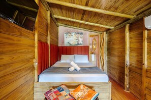 A wooden cabin room with a bed, red curtains, a painting on the wall, and a wooden headboard. - Cabin in Front of Beto Carrero W/bathtub Trs0004 (Penha)