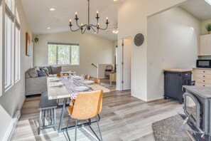 A modern kitchen with a dining area, a built-in stove, and a large window providing natural light. - Blue Sky Retreat w/ 3rd-Floor Mtn Views, Starlink (Bailey)