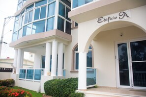A building with a sign reading 'Edificio A' and a balcony with columns. - Lovely  apartment with AC in vibrant Your Paradise Coastal Retreat in Nagua (Nagua)
