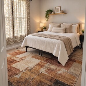 A bedroom with a bed, nightstands, a rug, and a window with curtains. - 6 Beds 5,000 SqFt Country Retreat: Sleeps the Whole Family w/ Resort Pool & Spa (Mohnton)