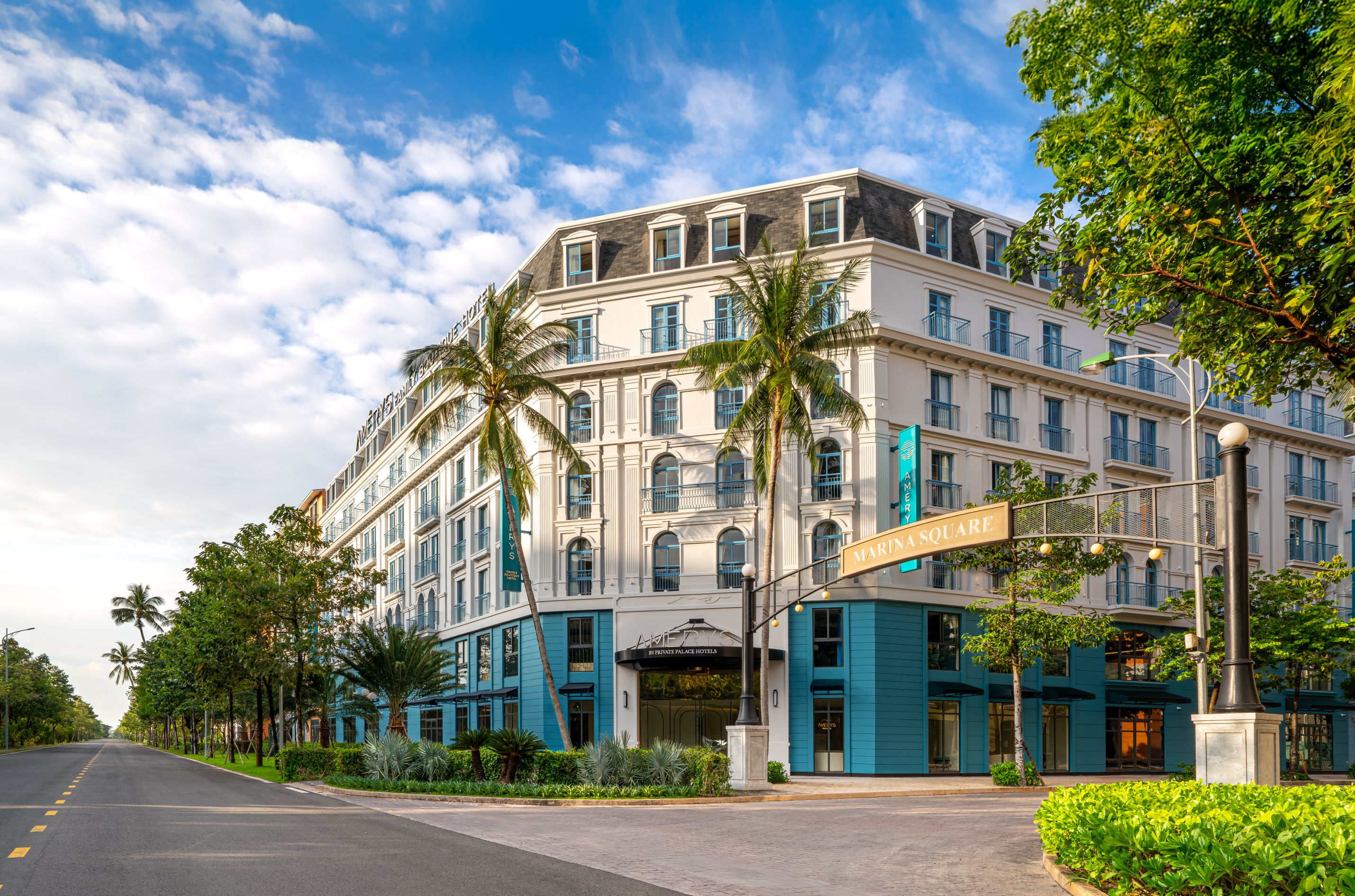 A multi-story hotel with a classic architectural style, featuring a prominent entrance and a balcony.