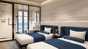 A modern bedroom with two beds, a large window with blinds, and a decorative wall pattern. - AMÉRYS Hotel Phu Quoc (Phu Quoc)