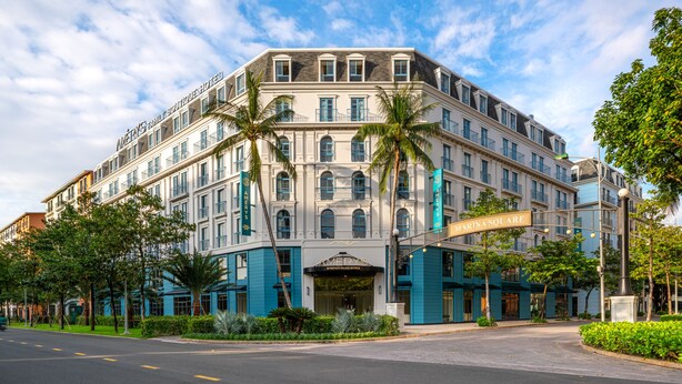 A multi-story hotel with a classic architectural style, featuring a prominent entrance and a balcony on the second floor. - AMÉRYS Hotel Phu Quoc (Phu Quoc)