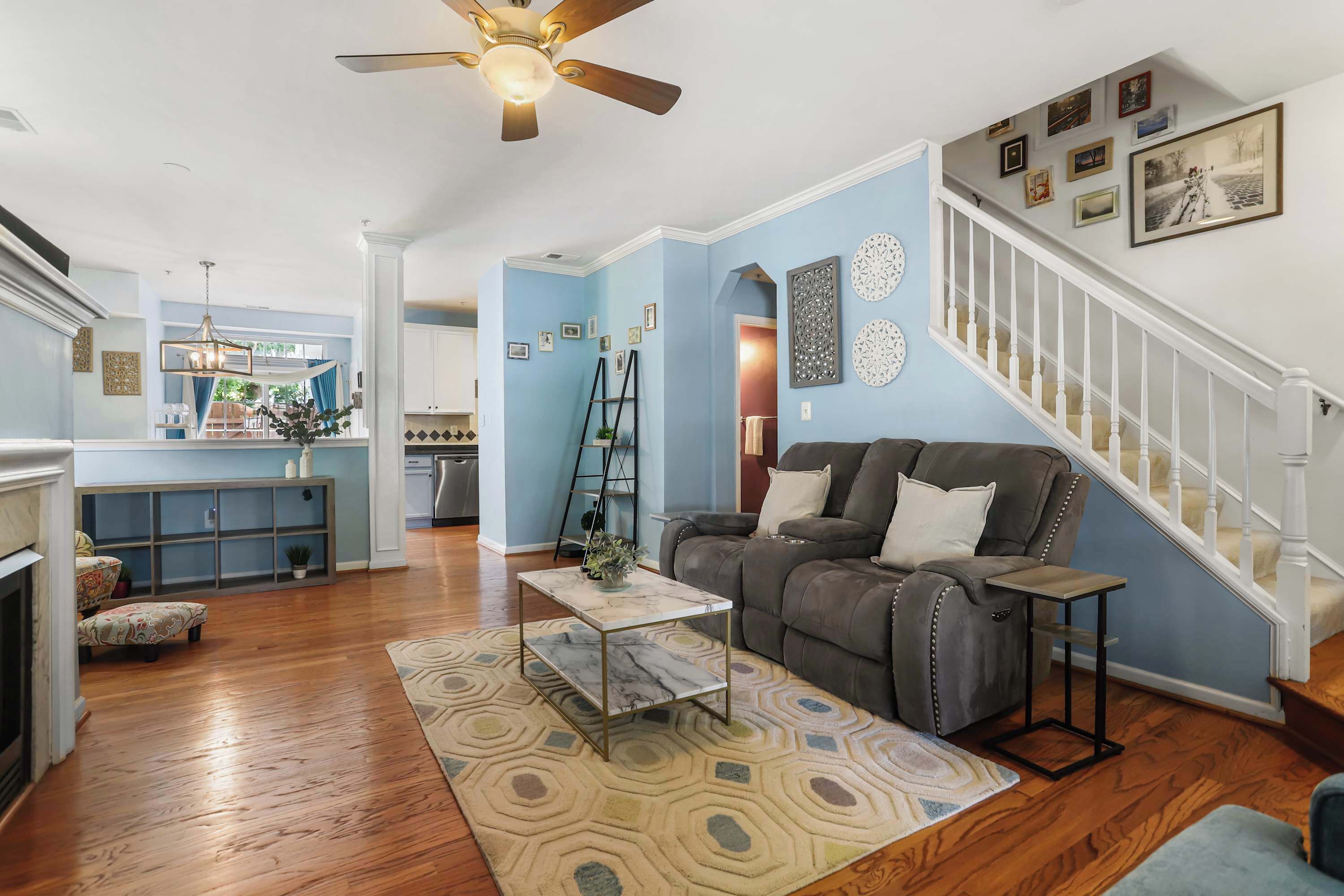 A living room with a sofa, coffee table, and a staircase.