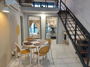 A modern interior with a dining area, a staircase, and a bedroom with a bunk bed. - CozyStay 3BR at Arte Cheras 4-Min Walk to MRT & Close to TRX/KLCC/Bukit Bintang (Kuala Lumpur)